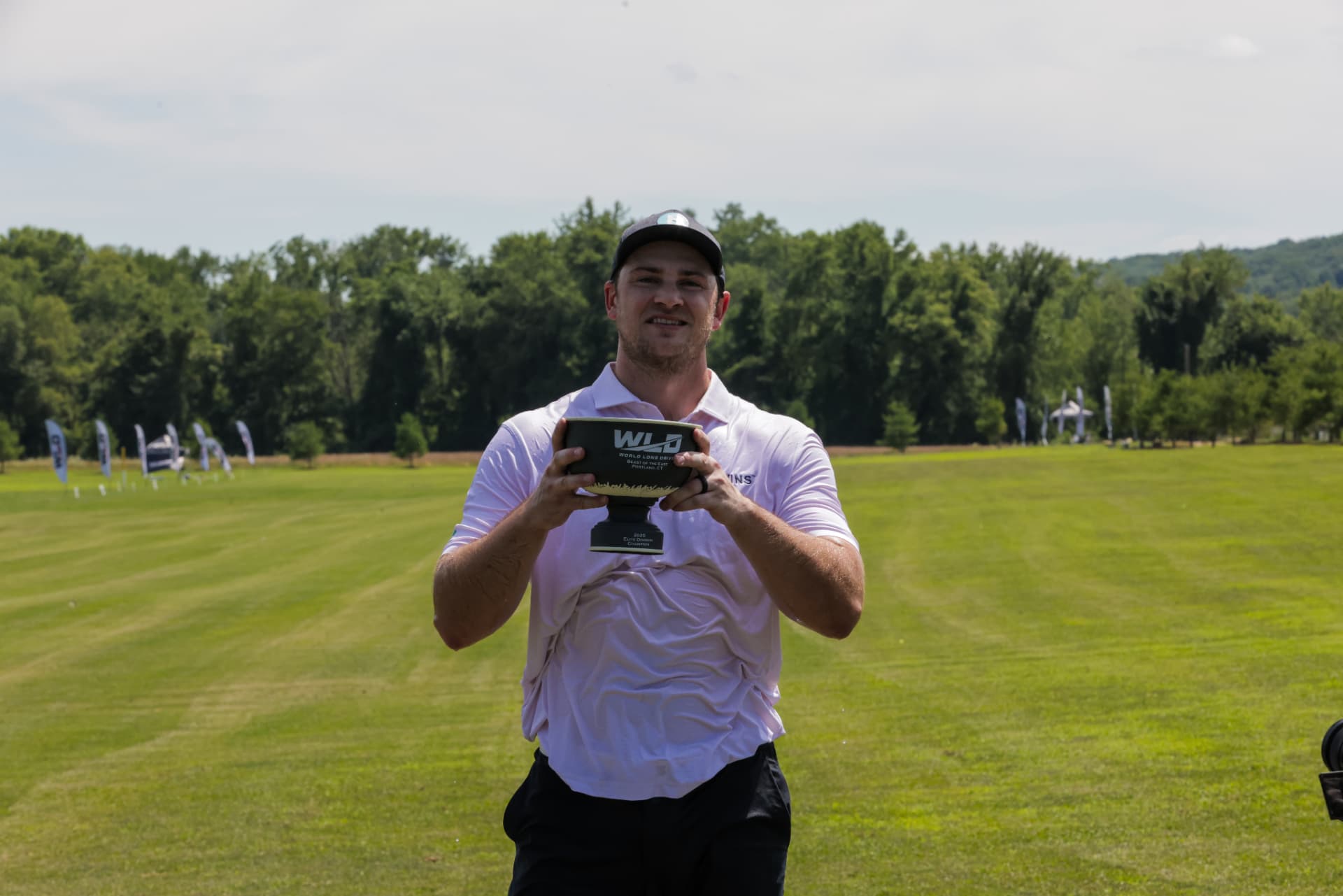Champion lifting the World Long Drive trophy